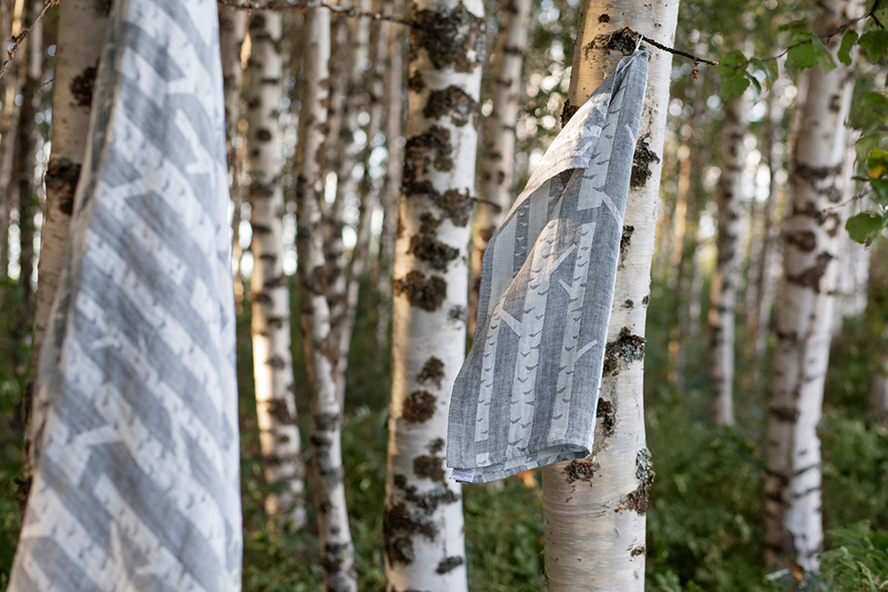 Tea towels by Lapuan Kankurit made from linen and decorated with a Finnish birch tree pattern, showing the significance of nature in textile design.